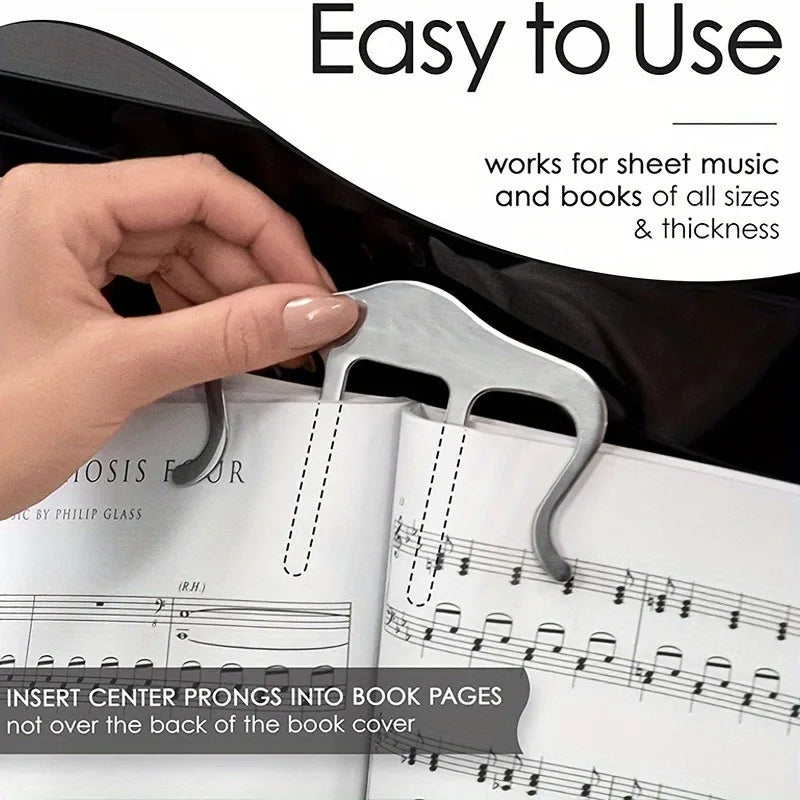 Hand positioning a silver book clip over an open sheet-music book.