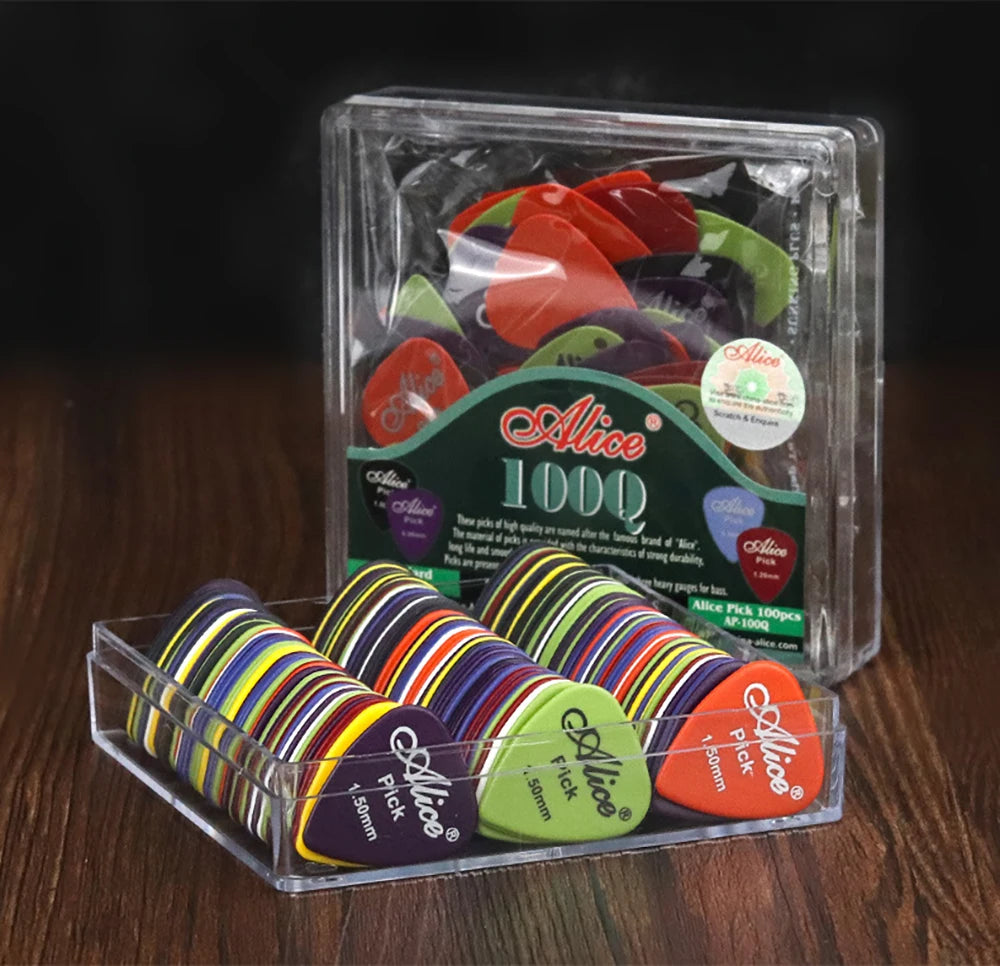 Multicolored Alice guitar picks in a clear tray beside their packaging.