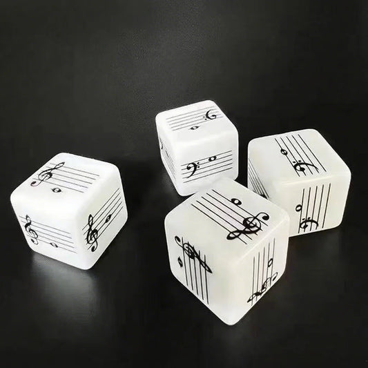White dice printed with black musical staves, notes and clefs on a dark surface.