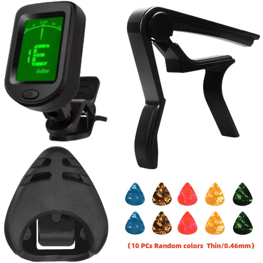 Black clip-on tuner, capo and pick holder beside colorful guitar picks.