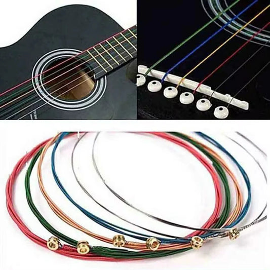 Coiled multicolored guitar strings with close-ups installed on a black acoustic guitar.