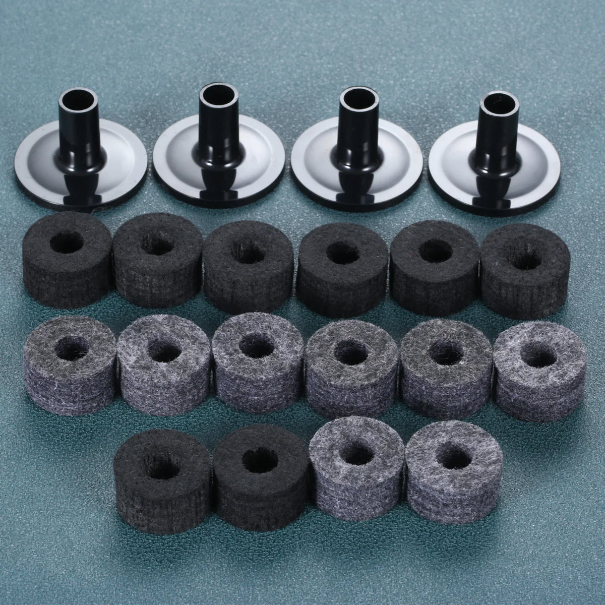 Black and gray cymbal felts arranged beneath black cymbal sleeves.